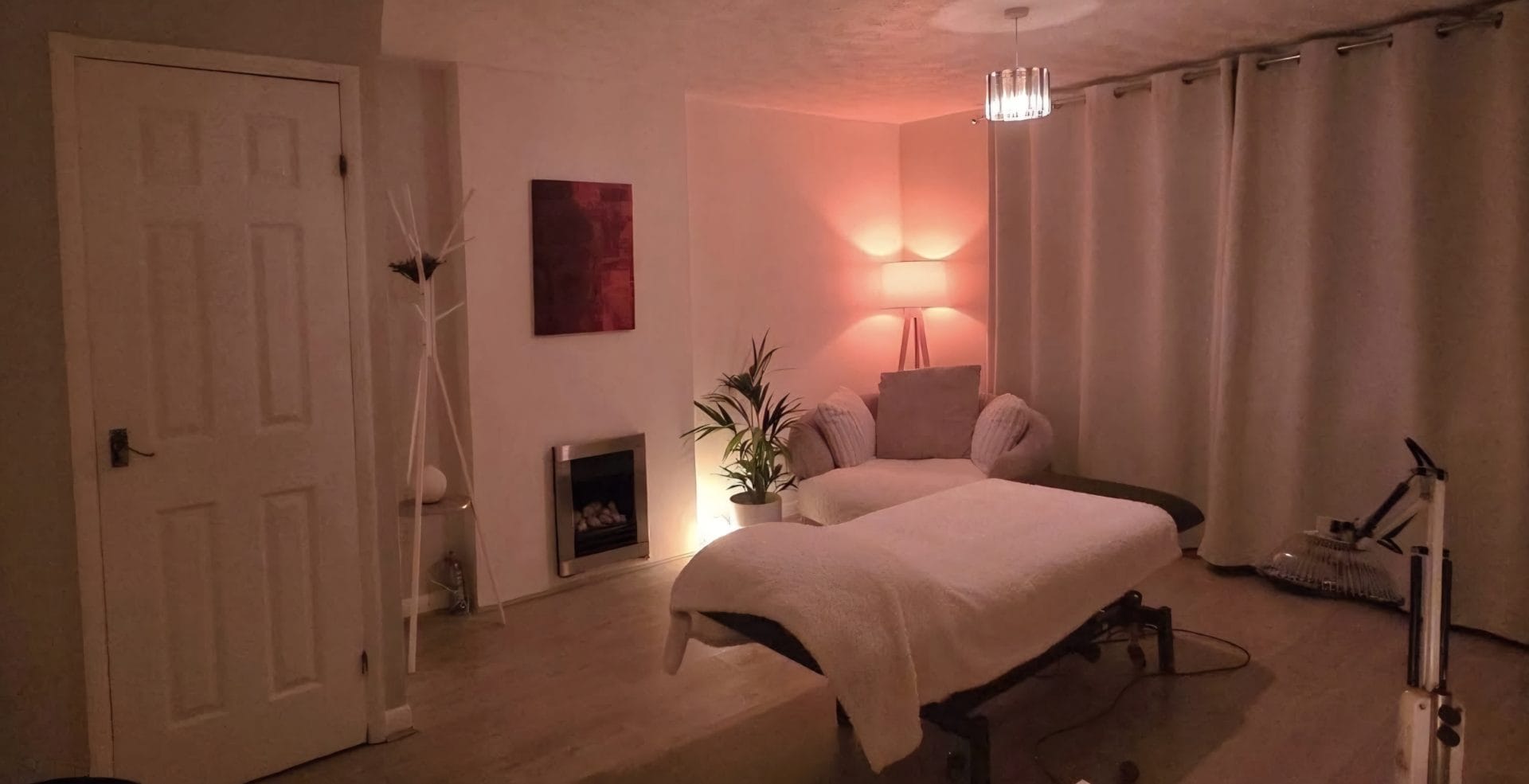 Purple treatment room with massage bed at D.r.E Therapy